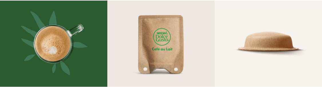 tak met bladeren naast een kop koffie met melk en een sachet