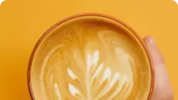 Hand die cappuccino kop vasthoudt